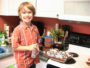 Levi decorating the cake.